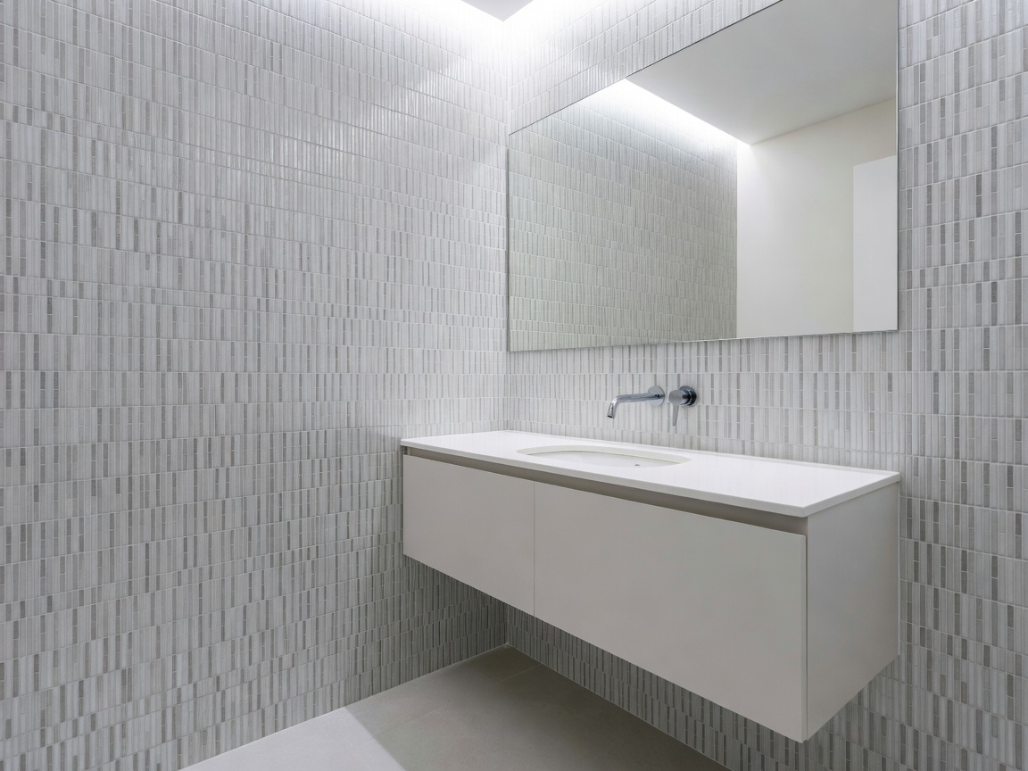 Compact modern bathroom with vertical micro mosaic tiles and wall-hung vanity